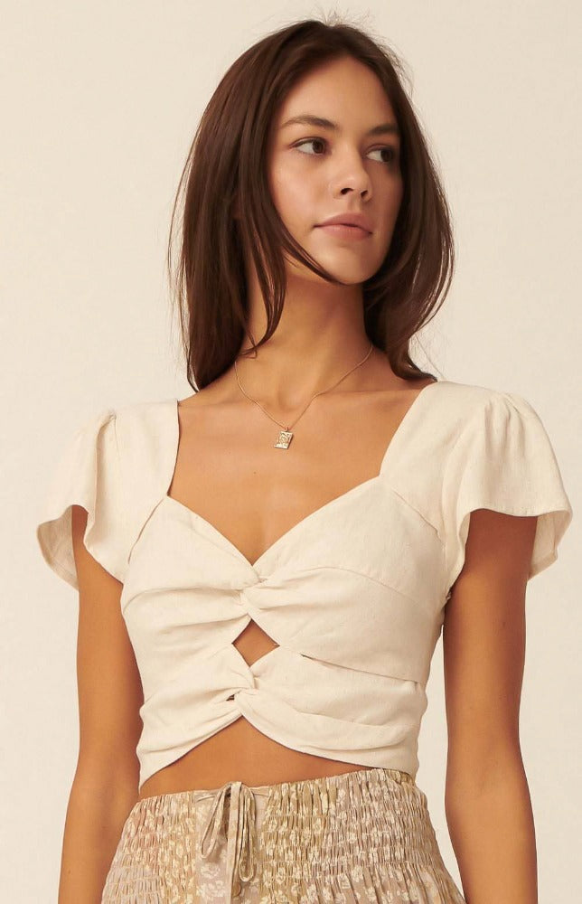 Don't go another second without the Simone Sweetheart Neck Double Twist Crop Top. A solid woven top with a stunning double twist design.  A Sweetheart neckline shapes this top that has cropped bodice gathered together at the front. Finished with short cap sleeves with flowy arm cuffs. 