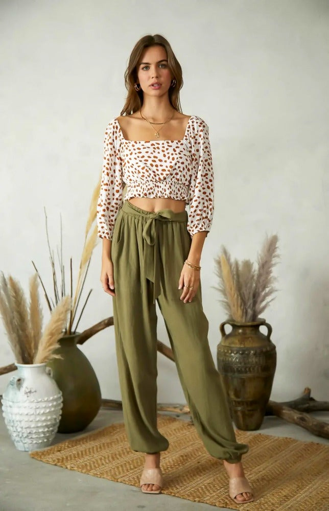 Going for a comfortable but cute look, then look no further than the Everly cut out back top. The cropped Everly top has a smocked waist and tie back detail. This top will elevate any pair of jeans that you pair her with.  