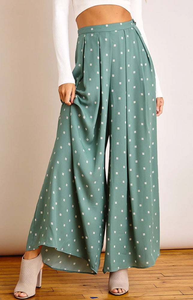 Keep it breezy this sunny season with the Julia square-dot print wide-leg pants! Lightweight woven fabric, with white square-dot print, shapes these pants that have a high, banded waist and flowy legs that ends at ankle-length hems. Hidden side zipper with button detail. Pair with the Jenny Radiate Positivity tee for a complete look!