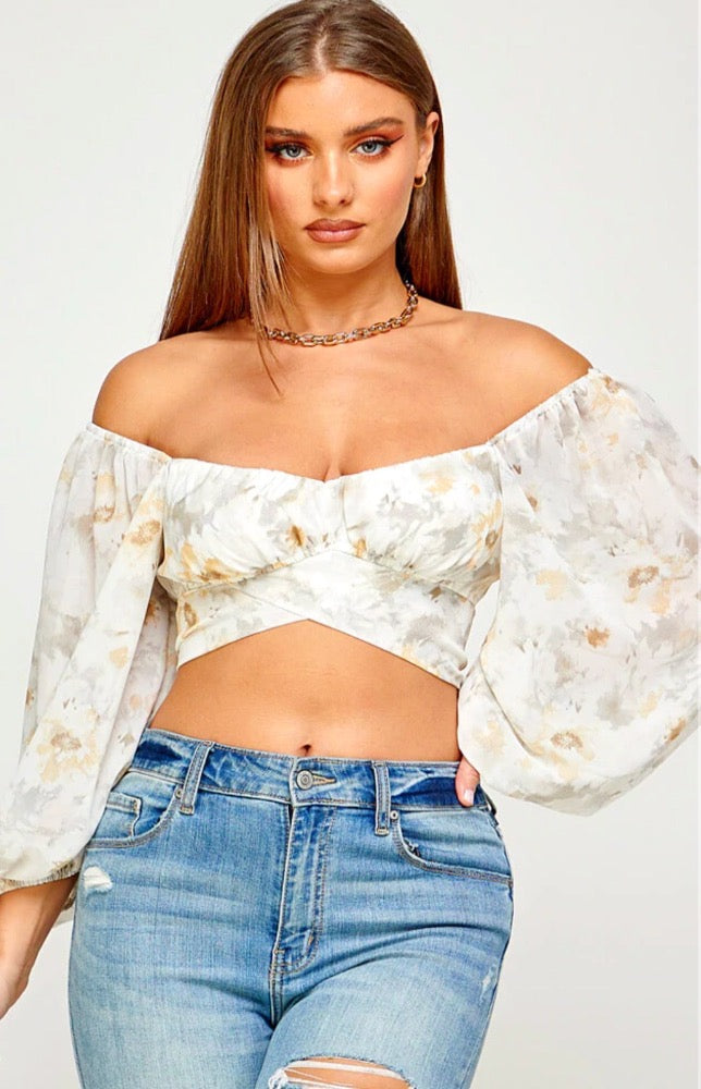 The Chloe Puff Sleeve Crop Top is the easiest way to sport this season's hottest trend! Lightweight woven fabric shapes this cute top that has a sweetheart neckline and extra puffy short sleeves with elastic at the cuffs. The fitted bodice has cross detail accent and ends at a cropped hem. Open back with tie ribbon strap.