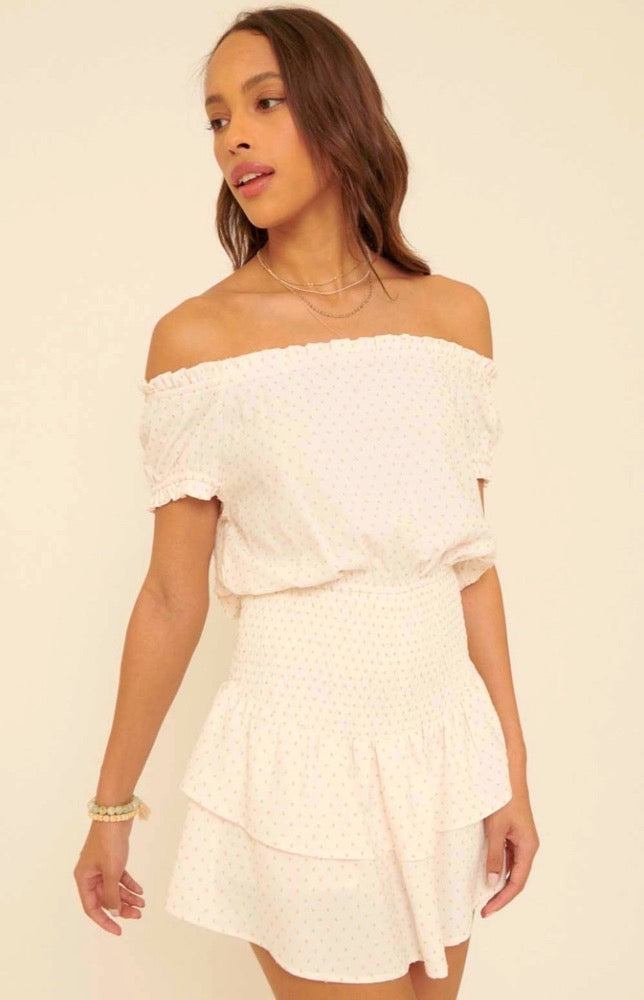 Throw on the Mikayla Blissful Cream Off-the-Shoulder Smocked Romper for a simply perfect, one-and-done look! Textured woven fabric shapes an elasticized, off-the-shoulder neckline with short, ruffled sleeves, accented with cute polka dot print all over. Smocked bodice creates a perfect fit atop matching shorts with overlapping tiers of beautiful breezy fabric.