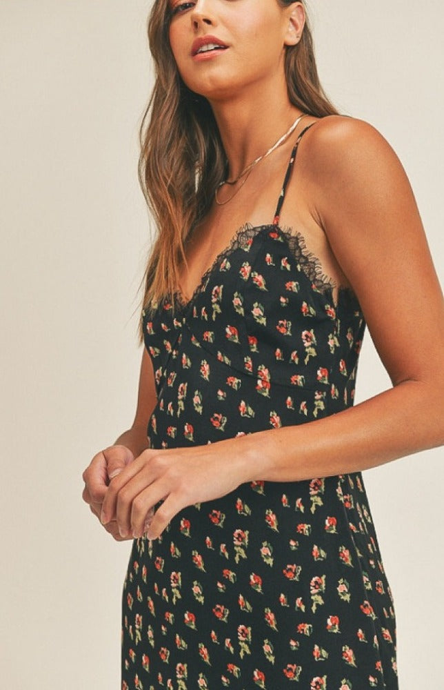 Start the night off by stunning in the Madison, but we're calling her Maddie, Mini Dress! Sleek soft fabric, with a bold green and red floral print, shapes this dress that has adjustable straps and a laced trimmed V-neckline.  
