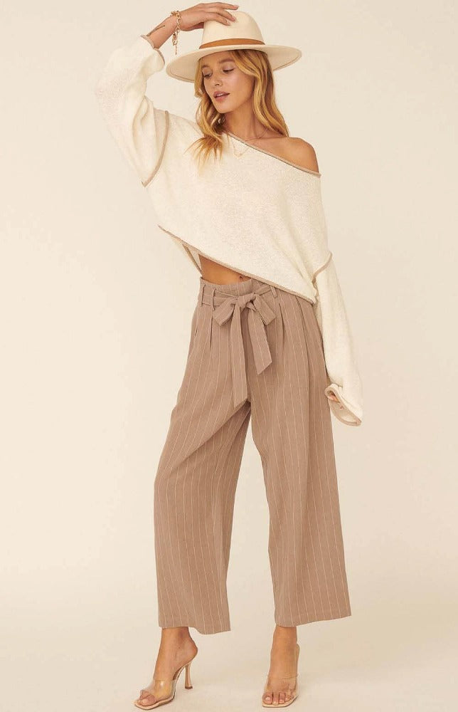 We are head over heels in love with the Katrina Woven Pinstripe Belted Paper Bag Wide Leg Pants. These cuties come with an ivory pinstripe detailed down to the ankle. The tie ribbon belt creates a paper bag waist. Dress these beauties up with heals and a blouse or down with a fitted bodysuit and flats.