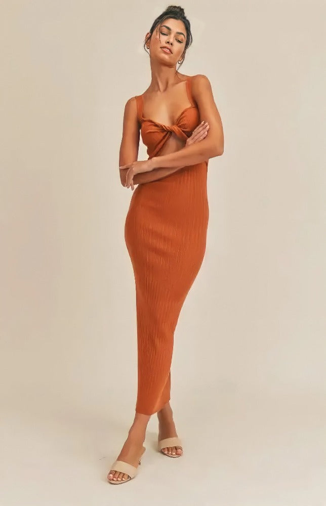Give your style an upgrade with the Grace Twist Front Cutout Midi Dress! Ribbed stretch knit shapes this cute dress that has a low-cut neckline, twist-front bodice, and thick tank sleeves. A cutout at the waist tops a figure-skimming column skirt that ends above them ankle with a back slit. 