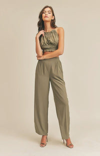 Take it easy in the Remi Halter Crop Top and Palazzo Pants Set in Olive! Woven fabric shapes this sleek and casual set that includes a ruched-detail crop top with a halter neckline, and lace-up back. Matching high-waisted Palazzo pants have wide, tulip pant legs and side pockets.