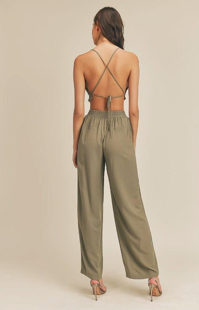 Take it easy in the Remi Halter Crop Top and Palazzo Pants Set in Olive! Woven fabric shapes this sleek and casual set that includes a ruched-detail crop top with a halter neckline, and lace-up back. Matching high-waisted Palazzo pants have wide, tulip pant legs and side pockets.