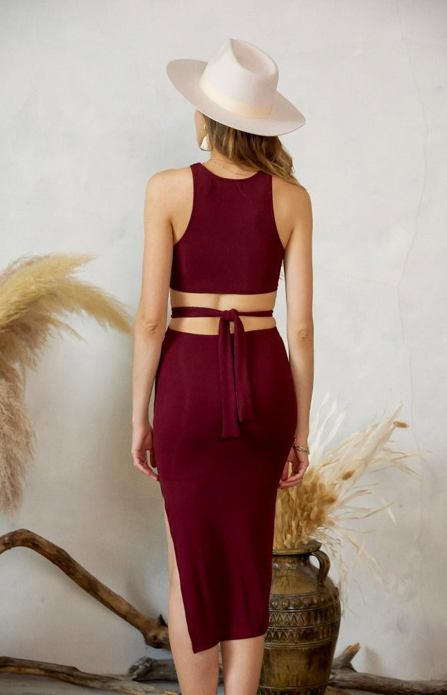 Robin has a sleek body contour that provides a slimming silhouette. She has a soft stretch fabric, midi length, side slit and tie around the waist that highlights the cut out back detail. Step into this dress to give everyone something to talk about.  