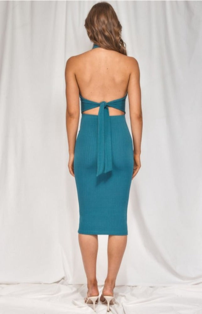 It's impossible to resist the Luna Halter Neck Dress. This stretchy jersey knit dress will hug each and every curve. The Luna has a tying halter neckline and a fitted, sleeveless bodice. Cutout back waist is accented by a tie back detail that tops a figure-skimming bodycon skirt with a midi hem.  