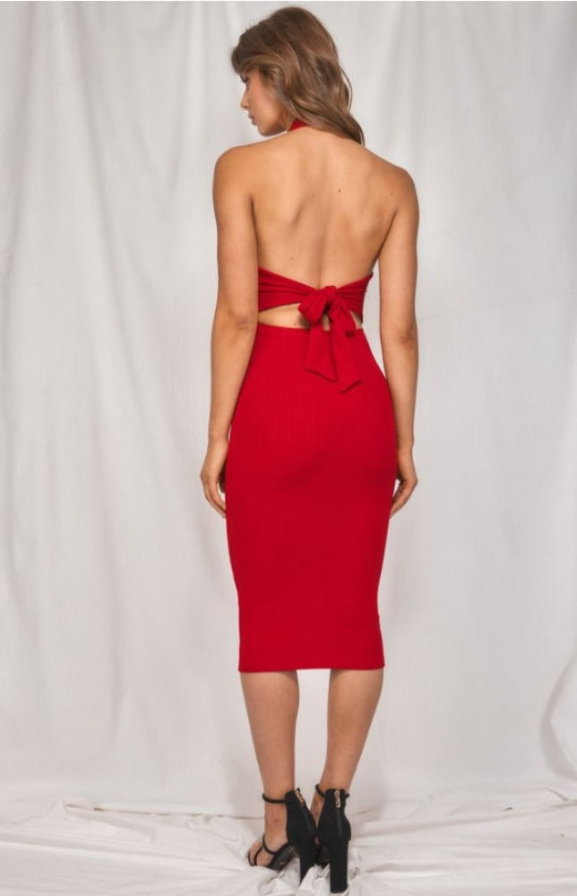 It's impossible to resist the Luna Halter Neck Dress in red. This stretchy jersey knit dress will hug each and every curve. The Luna has a tying halter neckline and a fitted, sleeveless bodice. Cutout back waist is accented by a tie back detail that tops a figure-skimming bodycon skirt with a midi hem.  