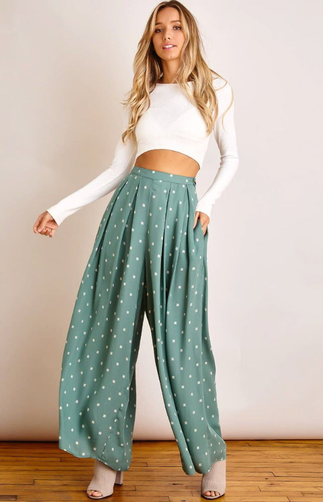 Keep it breezy this sunny season with the Julia square-dot print wide-leg pants! Lightweight woven fabric, with white square-dot print, shapes these pants that have a high, banded waist and flowy legs that ends at ankle-length hems. Hidden side zipper with button detail. Pair with the Jenny Radiate Positivity tee for a complete look!