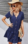 The Sophia Navy Blue Button-Up Mini Dress is what daydreams are made of! Light and breezy fabric creates this perfect sundress with cuffed arm sleeves, a V-neckline, and a cute ruffled hem. Delicate buttons add a darling detail as they travel down the front to an A-line mini skirt with a high, loose waist and seamed, ruffle hem.