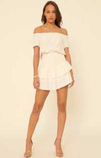 Throw on the Mikayla Blissful Cream Off-the-Shoulder Smocked Romper for a simply perfect, one-and-done look! Textured woven fabric shapes an elasticized, off-the-shoulder neckline with short, ruffled sleeves, accented with cute polka dot print all over. Smocked bodice creates a perfect fit atop matching shorts with overlapping tiers of beautiful breezy fabric.