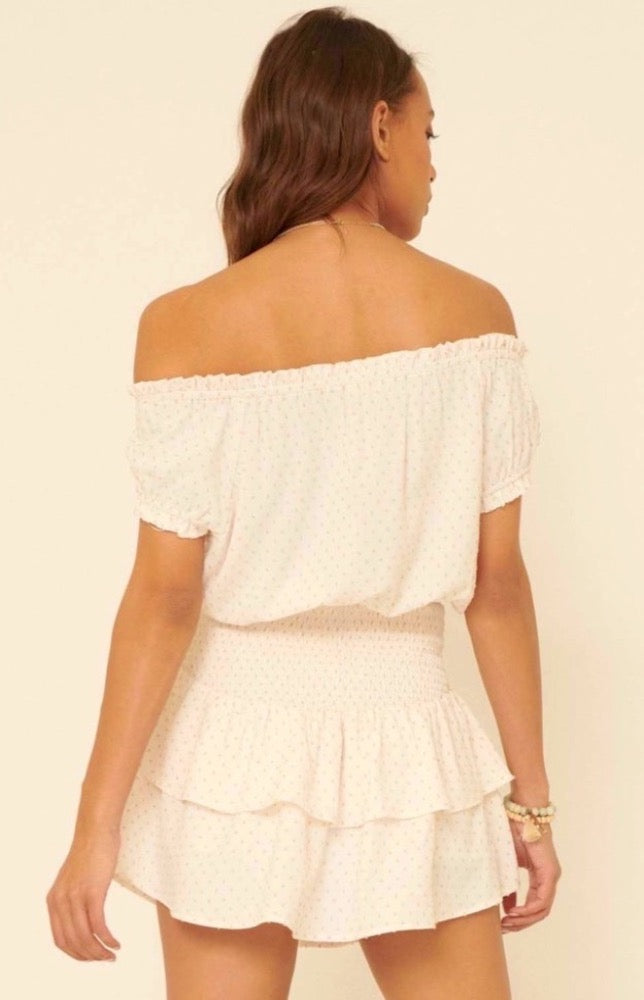 Throw on the Mikayla Blissful Cream Off-the-Shoulder Smocked Romper for a simply perfect, one-and-done look! Textured woven fabric shapes an elasticized, off-the-shoulder neckline with short, ruffled sleeves, accented with cute polka dot print all over. Smocked bodice creates a perfect fit atop matching shorts with overlapping tiers of beautiful breezy fabric.