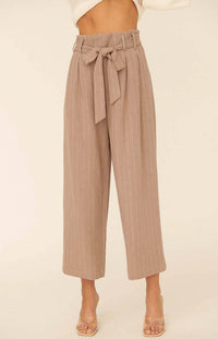 We are head over heels in love with the Katrina Woven Pinstripe Belted Paper Bag Wide Leg Pants. These cuties come with an ivory pinstripe detailed down to the ankle. The tie ribbon belt creates a paper bag waist. Dress these beauties up with heals and a blouse or down with a fitted bodysuit and flats.