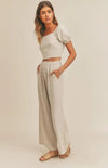 The Emery set has a delicate and airy feel. The top's lace-up back detail will make a statement as you work any room. The matching wide leg pant pair well with the top making for a very tailored look. Wear this fit during your daily errand runs with a flat  mule for a fun and causal look; or spice her up with a nude or clear heel for the evening.  