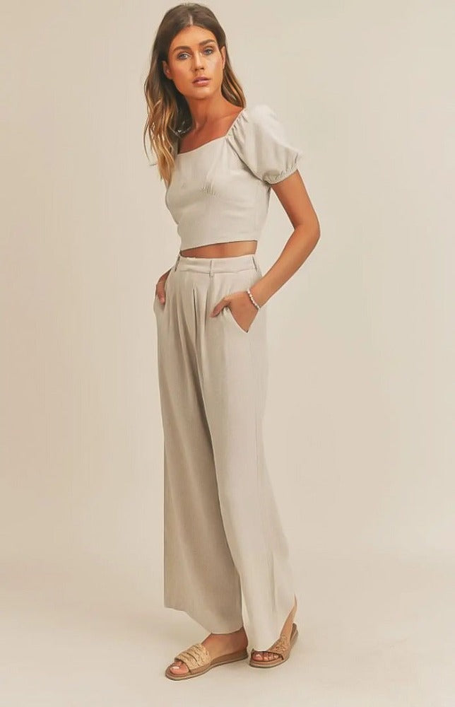 The Emery set has a delicate and airy feel. The top's lace-up back detail will make a statement as you work any room. The matching wide leg pant pair well with the top making for a very tailored look. Wear this fit during your daily errand runs with a flat  mule for a fun and causal look; or spice her up with a nude or clear heel for the evening.  