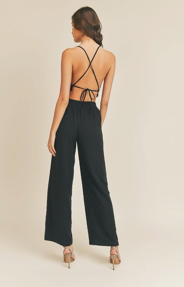 Take it easy in the Remi Halter Crop Top and Palazzo Pants Set in Black! Woven fabric shapes this sleek and casual set that includes a ruched-detail crop top with a halter neckline, and lace-up back. Matching high-waisted Palazzo pants have wide, tulip pant legs and side pockets.