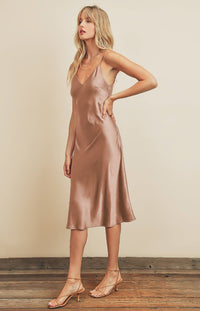 Slide into the Calla satin slip dress when you going for an easy and classy look. This sleek stretch-woven satin dress begins with a flirty V-neckline that tops a fitted bodice. She features a figure-skimming, midi silhouette and adjustable spaghetti straps. 