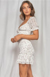 The Zoe Dainty Floral Shirred Dress in white will have you imbued romance. The delicate floral print highlights the details from the puff sleeves with ruffled arm band to the sweetheart neckline. The shirred bodice leads to a fun and flirty loose ruffle hem. This effortless, lightweight piece can go from day to night, city to beach.