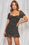 The Zoe Dainty Floral Shirred Dress in black will have you imbued romance. The delicate floral print highlights the details from the puff sleeves with ruffled arm band to the sweetheart neckline. The shirred bodice leads to a fun and flirty loose ruffle hem. This effortless, lightweight piece can go from day to night, city to beach.